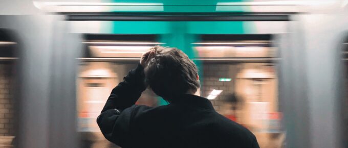 a man waiting at a subway