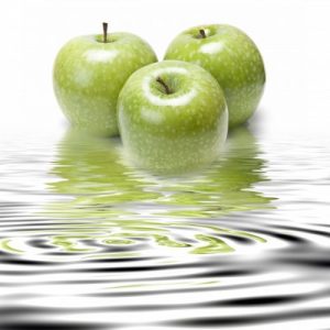 3 green apples sitting in clear water