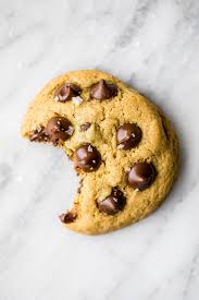 a chocolate chip cookie with a big bite in it.