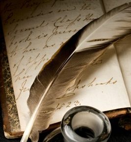 feather and ink pot on writing paper