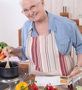 a smiling grandma stirring a pot in the kitchen