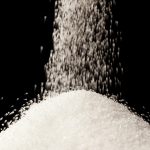 pouring sugar on a pile of sugar