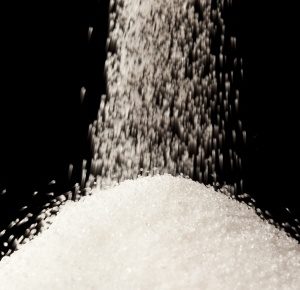 pouring sugar on a pile of sugar