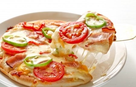 a veggie pizza with fresh tomatoes