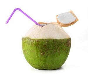 a raw coconut with a straw coming out of the top