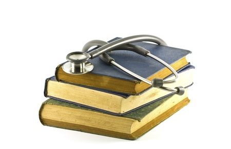3 old books with a stethoscope on top of them