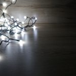 a string of Christmas lights on a dark background