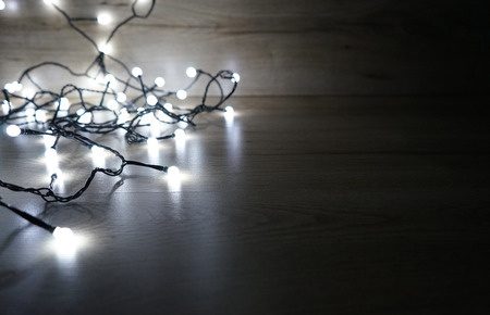 a string of Christmas lights on a dark background