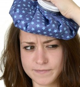 a teenager with an ice pack on her head with a hangover