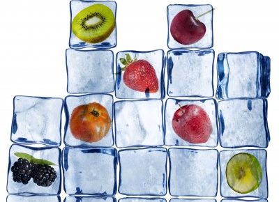 ice cubes stacked with frozen fruit in some of the cubes