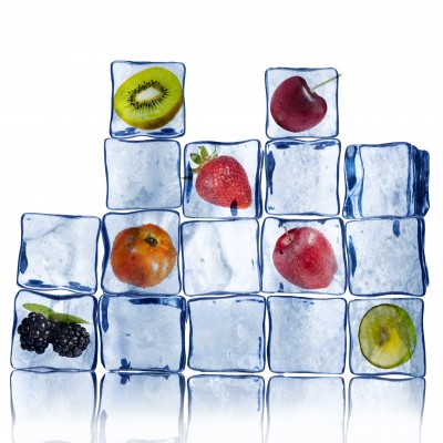 ice cubes stacked with frozen fruit in some of the cubes
