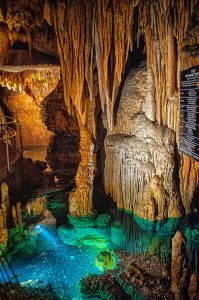 stalactites and stalagmites in a beautiful blue cave