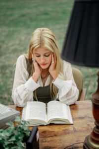 a beautiful blond girl reading a book