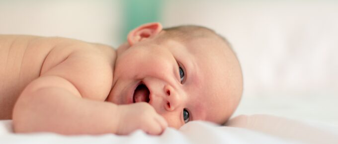 a baby laughing when on its tummy