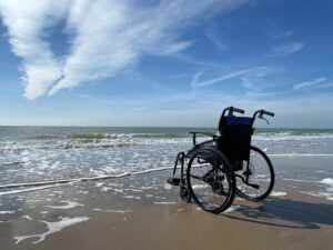 an empty wheelchair on the beach