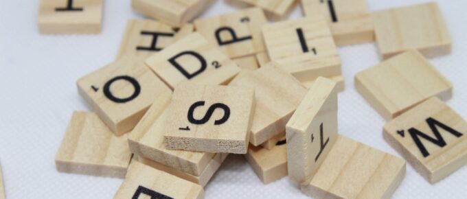 scrabble pieces piled on a table