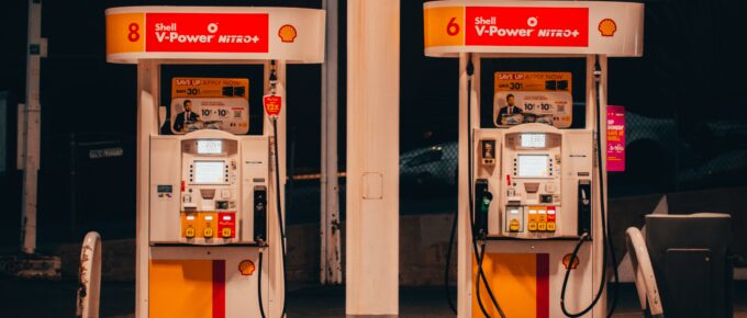 2 red gas pumps with a dark background